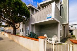 uma casa com duas cadeiras brancas em frente em Beach Living 1 em Newport Beach