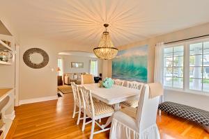 a dining room with a white table and chairs at Seashell Cottage in San Diego