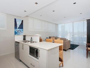 a kitchen with a sink and a counter top at Aura Apartments Unit 12 59 Shoal Bay Road in Shoal Bay