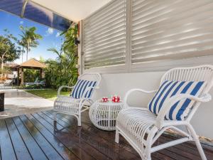 two chairs and a table on a porch at Belli Street 3 in Noosa Heads