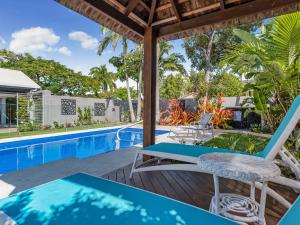 a patio with chairs and a swimming pool at Belli Street 3 in Noosa Heads