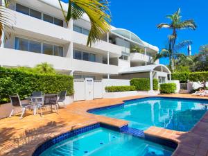 a swimming pool in front of a building at Cote DAzur 6 Douglas Street 6 in Sunshine Beach