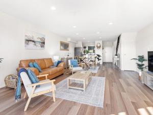 a living room with a couch and a table at Horizons Fairway Views Townhouse 108 in Salamander Bay