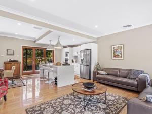 a living room with a couch and a table at Private coastal getaway Corlette in Corlette