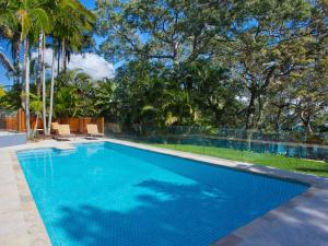 a swimming pool in a yard with trees at Park Cove 4 Park Road 48 in Noosa Heads