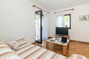 a living room with a couch and a table at Apartments Vienna in Zambratija