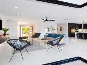 a living room with a couch and a table and chairs at Seamount Quay 22 in Noosaville