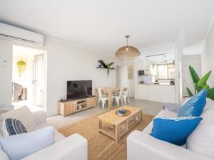 a living room with two white couches and a table at Bay Village Unit 2 47 Shoal Bay Road in Shoal Bay