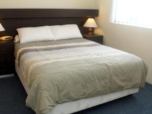 A bed or beds in a room at Bay Village Unit 20, 47 Shoal Bay Road