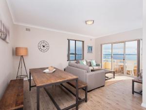 a living room with a couch and a table at Bay Village Unit 6 47 Shoal Bay Road in Shoal Bay