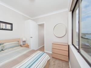 A bed or beds in a room at Bay Village, Unit 6/47 Shoal Bay Road