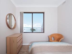 A bed or beds in a room at Bay Village, Unit 6/47 Shoal Bay Road