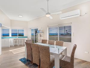 a dining room and living room with a table and chairs at Bayview Towers Unit 13 Victoria Parade 15 in Nelson Bay