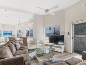 a living room with a couch and a tv at Bayview Towers Unit 13 Victoria Parade 15 in Nelson Bay