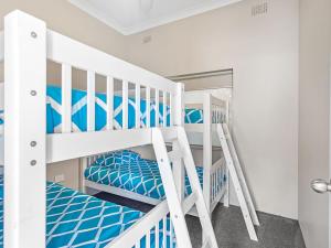 a bedroom with two bunk beds and a mirror at Bayview Towers Unit 13 Victoria Parade 15 in Nelson Bay