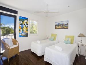 a white room with two beds and a window at Weyba Quays Townhouse 7 Peza Court 6 in Noosa Heads