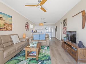 a living room with a couch and a tv at Bella Vista Unit 10 19 Shoal Bay Road in Shoal Bay