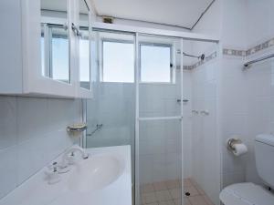 a white bathroom with a shower and a toilet at Bella Vista Unit 3 19 Shoal Bay Road in Shoal Bay