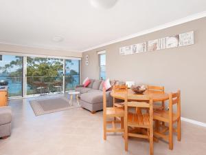 a living room with a table and a couch at Luskin Lodge Unit 15 29 Weatherly Close in Nelson Bay