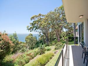 a balcony of a house with a view of the ocean at Mirage 1 24 Gloucester Street in Nelson Bay