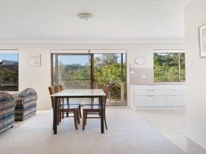 a kitchen and dining room with a table and chairs at Misthaven Unit 1 12 Mistral Close in Nelson Bay