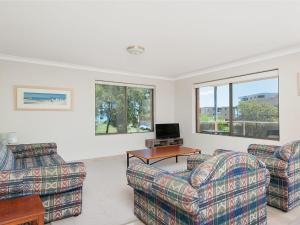 a living room with two couches and a television at Misthaven Unit 1 12 Mistral Close in Nelson Bay