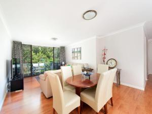 a dining room and living room with a table and chairs at Mistral Court Unit 16 17 Mistral Close in Nelson Bay