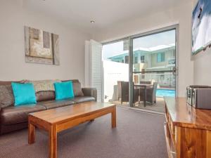 a living room with a couch and a coffee table at Pacific Blue Apartment 139, 265 Sandy Point Road in Salamander Bay