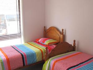 A bed or beds in a room at Pet Friendly Tomaree Rd 142 - Shoal Bay