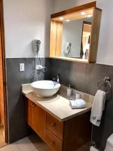 a bathroom with a sink and a mirror at Bayahibe Apartment in Cadaques in Bayahibe