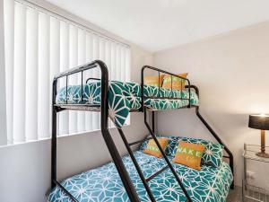 a bedroom with two bunk beds in a room at Portside Unit 8 1 Donald Street in Nelson Bay