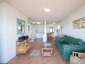 a living room with a couch and a table at Castaways Unit 4 17 Shoal Bay Road in Shoal Bay