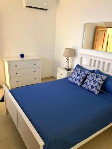 a bedroom with a bed and a dresser and a mirror at Bayahibe Apartment in Cadaques in Bayahibe