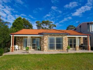 a brick house with an orange roof at Cook Street 4 in Salamander Bay
