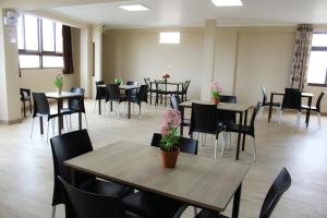 uma sala de jantar com mesas e cadeiras com flores em Gran Caral Hotel em Barranca