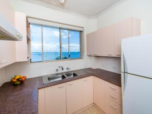 a kitchen with a sink and a large window at Del Rae Unit 8 25 Shoal Bay Road in Shoal Bay