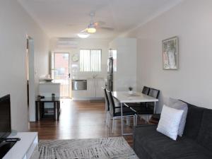 a living room with a couch and a table at Sand Sea 5 in Sawtell