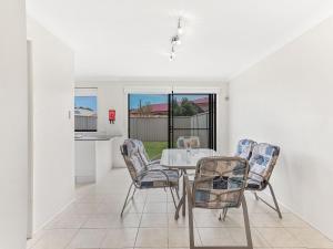 a dining room with a table and chairs at Fingal Sands 10A Fingal Bay in Fingal Bay