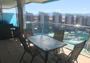 a table and chairs on a balcony with a view of a city at SEA AIR OCEAN VILLAGE in Gibraltar