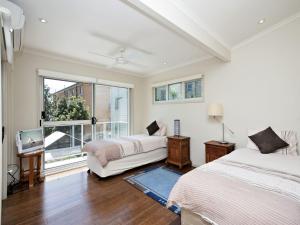 a bedroom with two beds and a window at Florida 5 5 Lillian Street in Shoal Bay