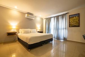 a hotel room with a bed and a window at Hotel Amoek in Cartagena de Indias +49 photos