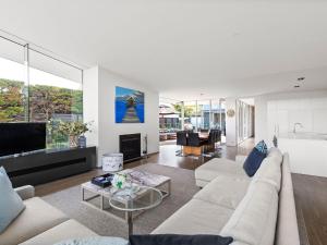 a living room with a couch and a table at The Belmond in Portsea