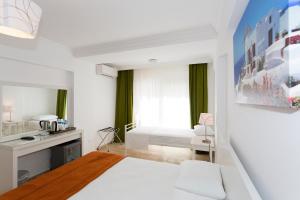 Postel nebo postele na pokoji v ubytování Ayka Hotel