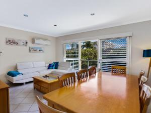 a living room with a table and a couch at Sandy Shores 1 3 Messines Street in Shoal Bay