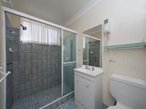 a bathroom with a shower and a toilet and a sink at The Breakers 16B Government Road in Shoal Bay