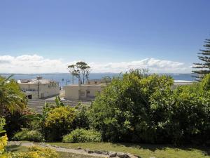 a view of a house with the ocean in the background at The Crest Unit 5 6 8 Tomaree Road in Shoal Bay