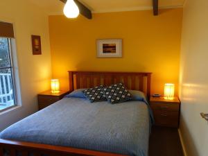 A bed or beds in a room at Wonky Pine Beach House, NARRWALLEE- 4 bedroom
