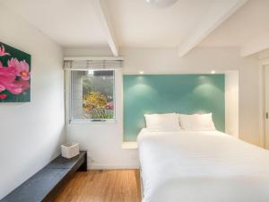 Llit o llits en una habitació de Tallwoods Beach House