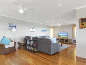 a living room with a couch and a chair at South Pacific Beach House in Ulladulla