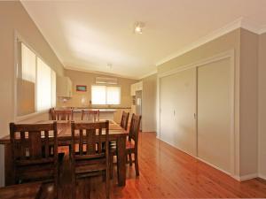 a dining room and kitchen with a table and chairs at Bring the Dog, Boat and Family in Burrill Lake